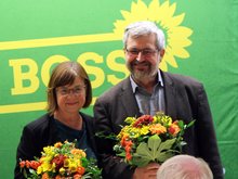 Vor der grünen Leinwand "Basis ist Boss" stehen die zwei Fraktionsvorsitzenden von BÜNDNIS 90/DIE GRÜNEN im Brandenburger Landtag, Ursula Nonnemacher und Axel Vogel. Beide haben einen Blumenstrauß in der Hand, den sie von den beiden Landesvorsitzenden Petra Budke und Clemens Rostock überreicht bekommen. Sie freuen sich beide über ihre Wahl mit 92,4 Prozent Zustimmung. Ernennen allerdings muss sie der Ministerpräsident.